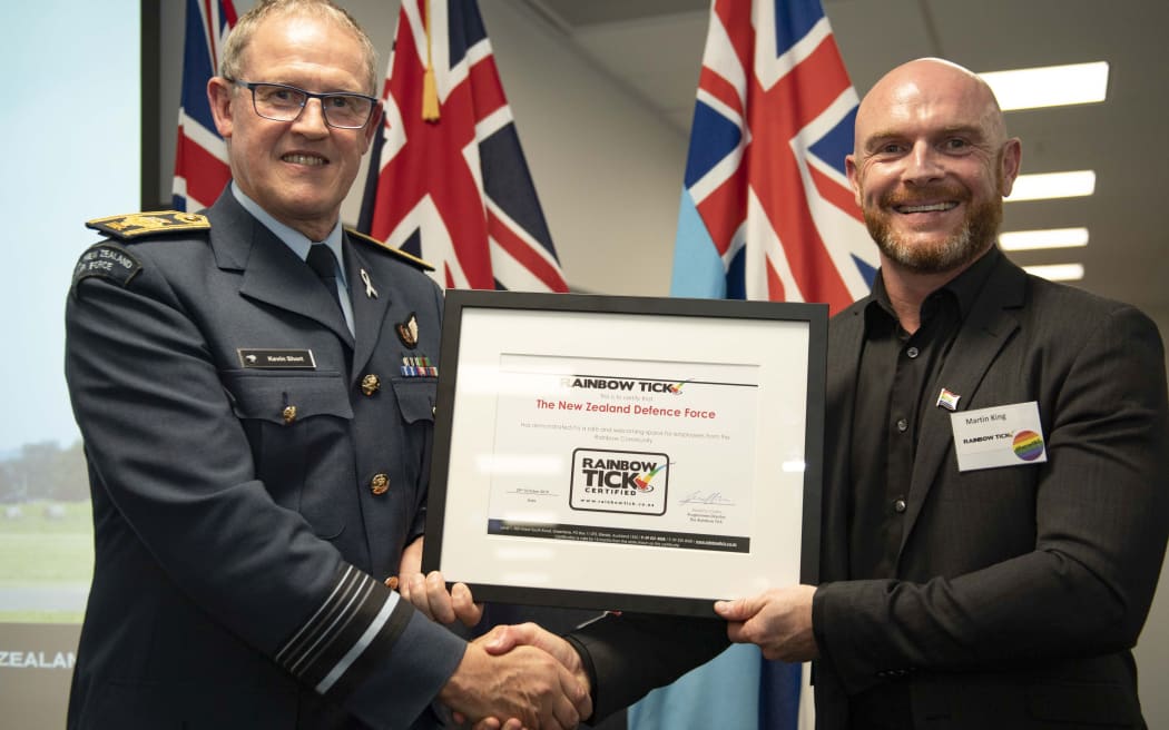 Chief of Defence Force Air Marshal Kevin Short receives the Rainbow Tick certificate form Director of Rainbow Tick Martin King.