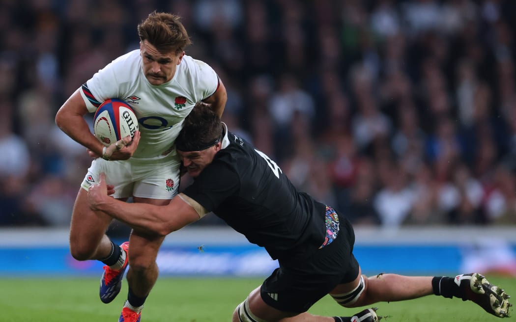 All Blacks captain Scott Barrett tackles England's George Furbank.