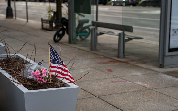 WASHINGTON, DC - NOVEMBER 27: A small memorial of flowers and an American flag has been set up outside the Farragut West Metro station on November 27, 2025 in Washington, DC. Two members of the West Virginia National Guard were shot on November 26 blocks from the White House in what authorities are calling a targeted shooting.   Andrew Leyden/Getty Images/AFP (Photo by Andrew Leyden / GETTY IMAGES NORTH AMERICA / Getty Images via AFP)