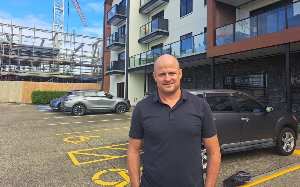 Dave Barr outside a retirement village development in Kumeū completed before Watercare constraints.