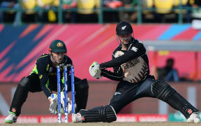 New Zealand's Colin Munro (R) plays a shot as Australia's wicketkeeper Peter Nevill looks on during the World T20 cricket tournament.