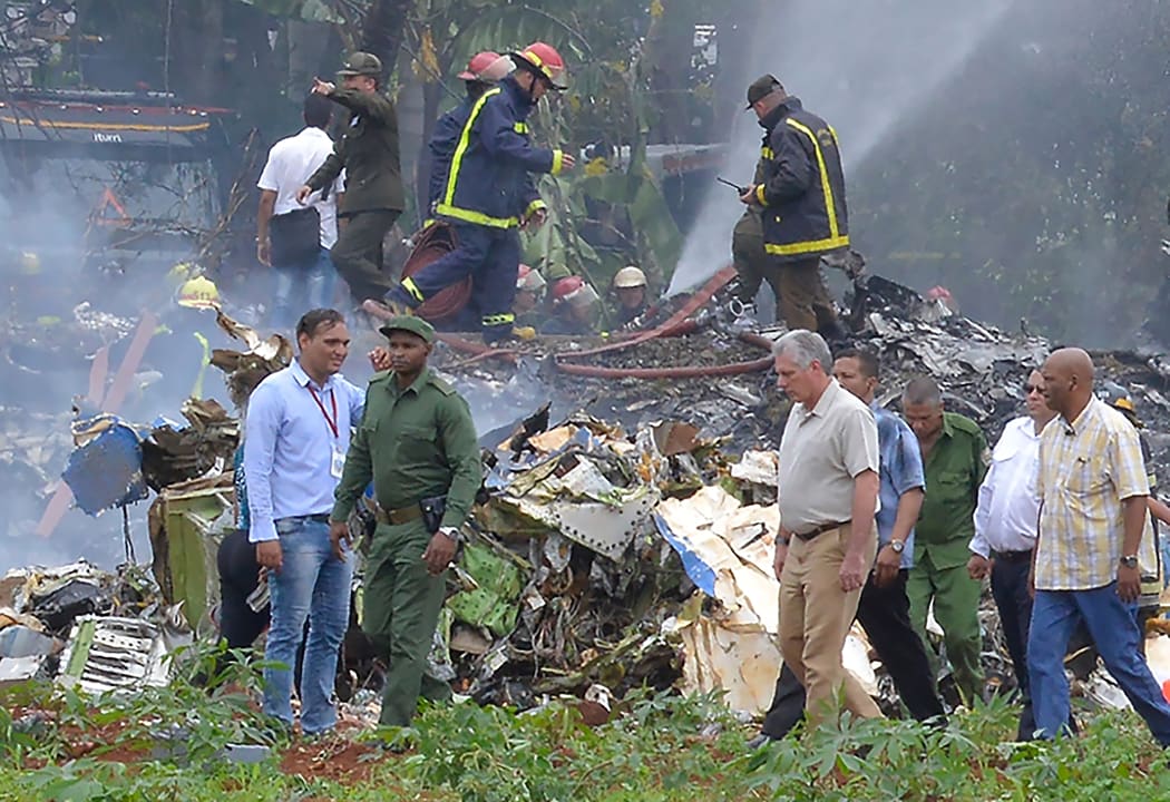 Cuban President Miguel Diaz-Canel (second from right) at the site of the accident after a Cubana de Aviacion aircraft crashed after taking off from Havana's Jose Marti airport on 18 May, 2018.