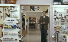 Man in suit in a general store.