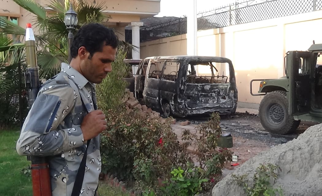 A member of the Afghan security forces walk at the site of an attack in Jalalabad.