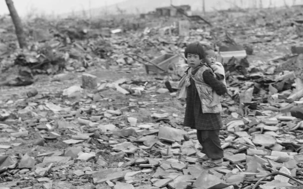 Small child and baby at Hiroshima [courtesy Alexander Turnbull Library]