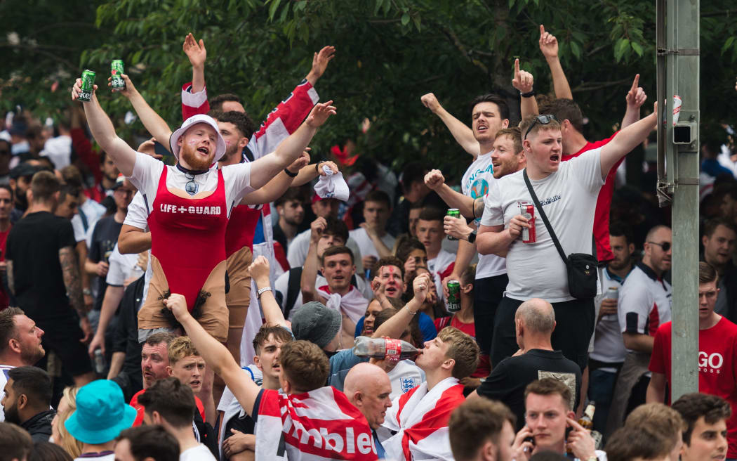 LONDON, UNITED KINGDOM - JULY 11, 2021: England football fans celebrate outside Wembley Stadium ahead of England match against Italy in the final of Euro 2020 Championship on July 11, 2021 in London, England.