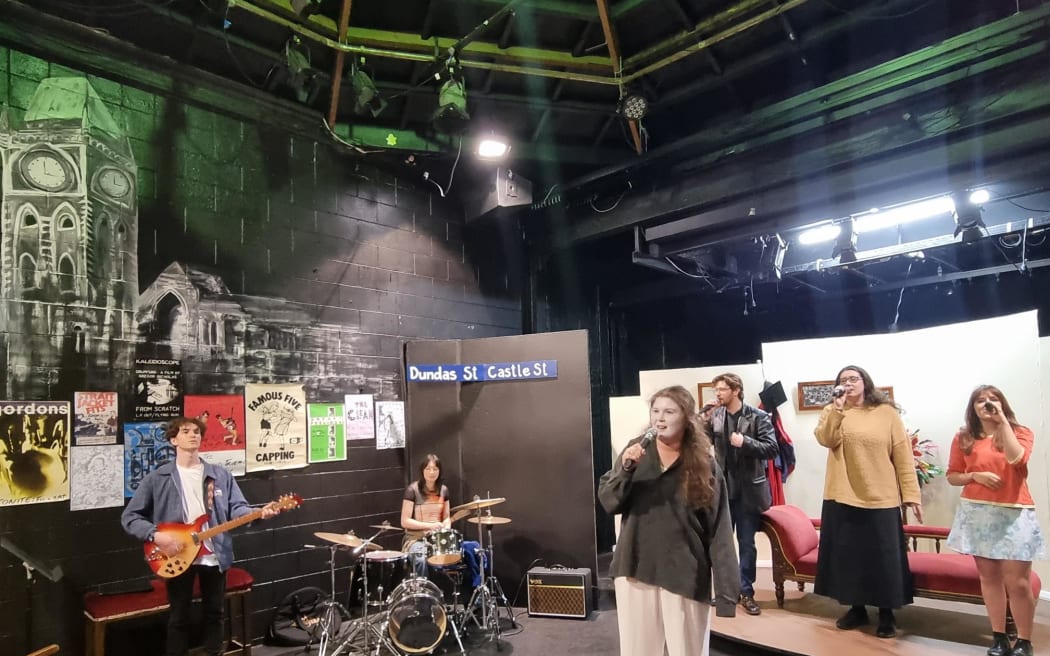 Musical director and guitarist Sam Miekle (far left) rehearses with the band and Aimee Freeman (centre) who plays Feste.