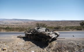 A damaged tank stands on a road north of Mekele, the capital of Tigray. - Ethiopian authorities on August 24, 2022 accused Tigray rebels of launching a new offensive against federal forces in the country's north, five months after a truce paused the worst of the fighting.
"Disregarding the numerous peace options presented by the Ethiopian government, the armed wing of the terror group TPLF (Tigray People's Liberation Front), pushing with its recent provocations starting 5 am (0200 GMT) today committed an attack" in a region around southern Tigray, the Government Communication Service said in a statement. (Photo by EDUARDO SOTERAS / AFP)
