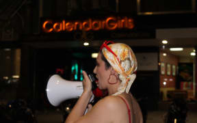 A protester addresses the crowd outside Calendar Girls in Wellington.