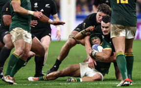 South Africa's Cheslin Kolbe is tackled by New Zealand's Will Jordan during the 2023 Rugby World Cup Final match between the All Blacks and the Springboks.