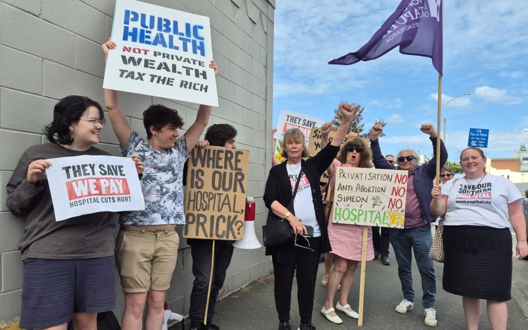 'They save we pay' campaigners in Dunedin.