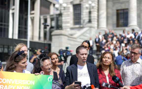 Green Party members and supporters rally in support of a ban on gay conversion therapy.