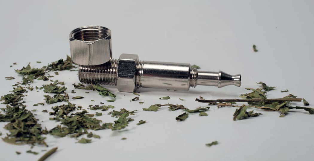 Synthetic cannabis and a pipe.