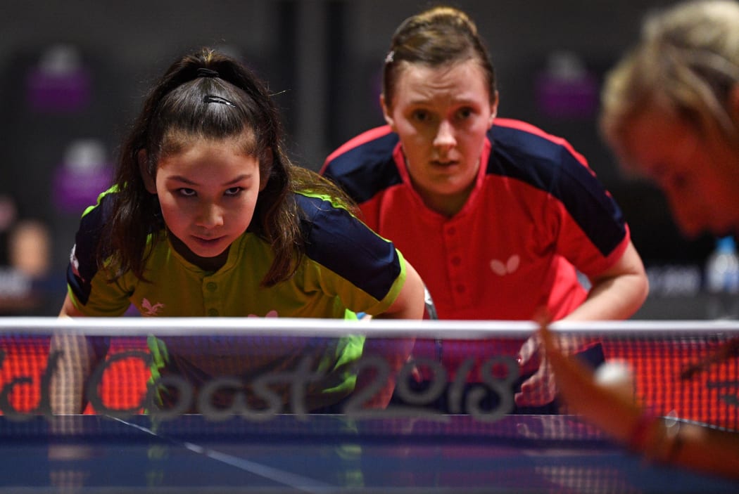 A photo taken on on April 2, 2018 shows eleven-year-old table tennis player Anna Hursey of Wales (L) preparing to return a serve with teammates Chloe Thomas (C) and Charlotte Carey (R) during training ahead of the 2018 Gold Coast Commonwealth Games.