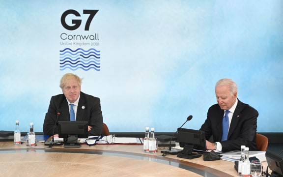 Britain's Prime Minister Boris Johnson (L) and US President Joe Biden sit around the table at the start of the G7 summit in Carbis Bay, Cornwall on 11 June 2021.