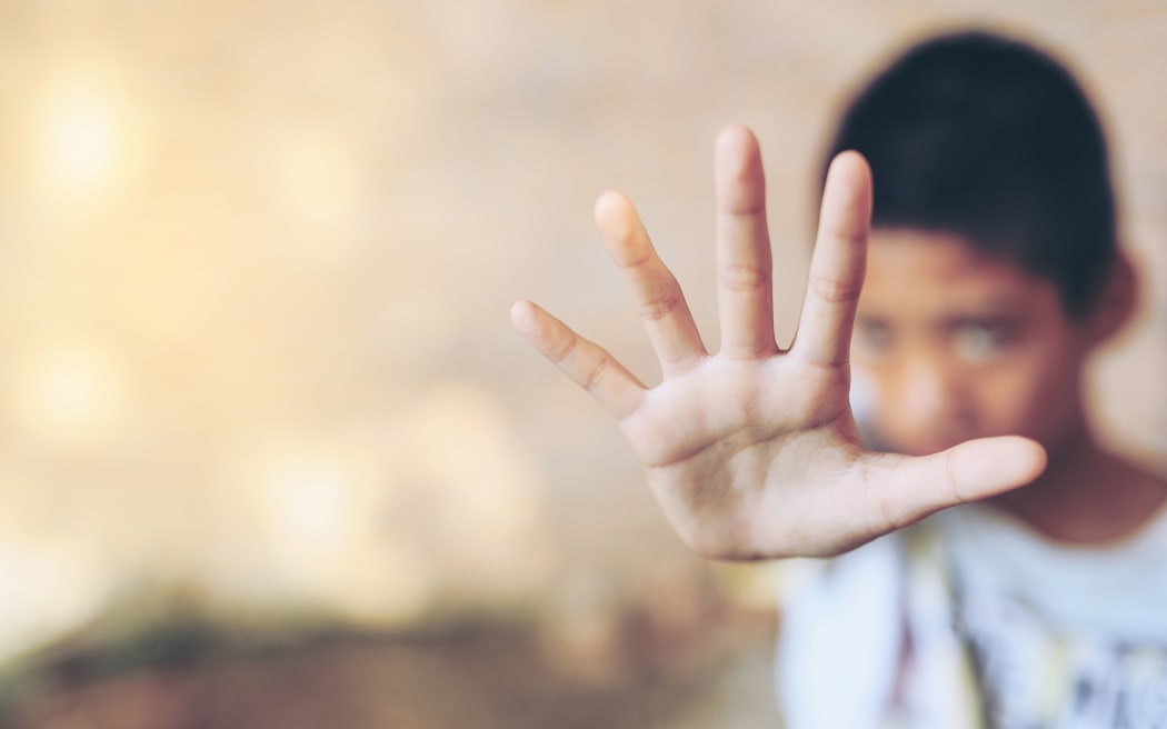 Children violence. boy, lad with her hand extended signaling to stop Children violence. boy, lad with her hand extended signaling to Stop, call for help, struggle, terrified, violence