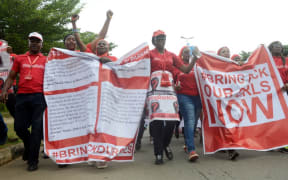 Supporters of the #BringBackOurGirls campaign march for the release of the 219 Chibok schoolgirls kidnapped by Boko Haram militants, in Abuja, on October 14, 2014.