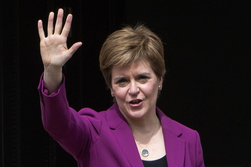 First Minister Nicola Sturgeon waves on the steps of her official residence  in Edinburgh following the SNP's victory in the Scottish parliament elections.
