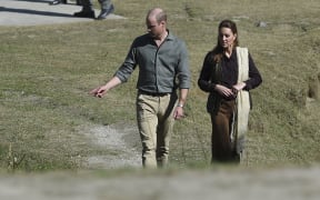 Britain's Prince William (L), Duke of Cambridge and his wife Catherine (R), Duchess of Cambridge, walks on their arrival at the Kalash tribe village in Bumburate Valley in Pakistan northern Chitral District on October 16, 2019.