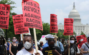 Demonstrators carrying signs gather near the U.S. Capitol during a protest against police brutality and racism on June 6, 2020 in Washington, DC.