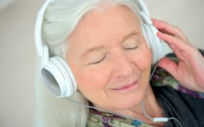 elderly woman with headphones