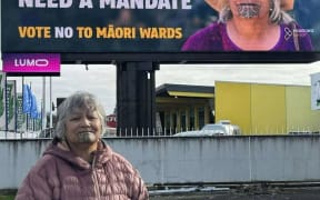 Ellen Tamati in front of a Hobson’s Pledge campaign using her face without authorisation.