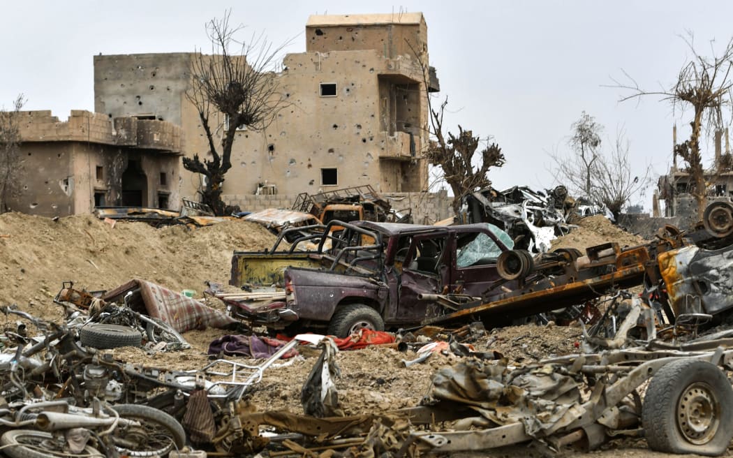 Destroyed vehicles and damaged buildings in the village of Baghouz in Syria's eastern Deir Ezzor province near the Iraqi border.