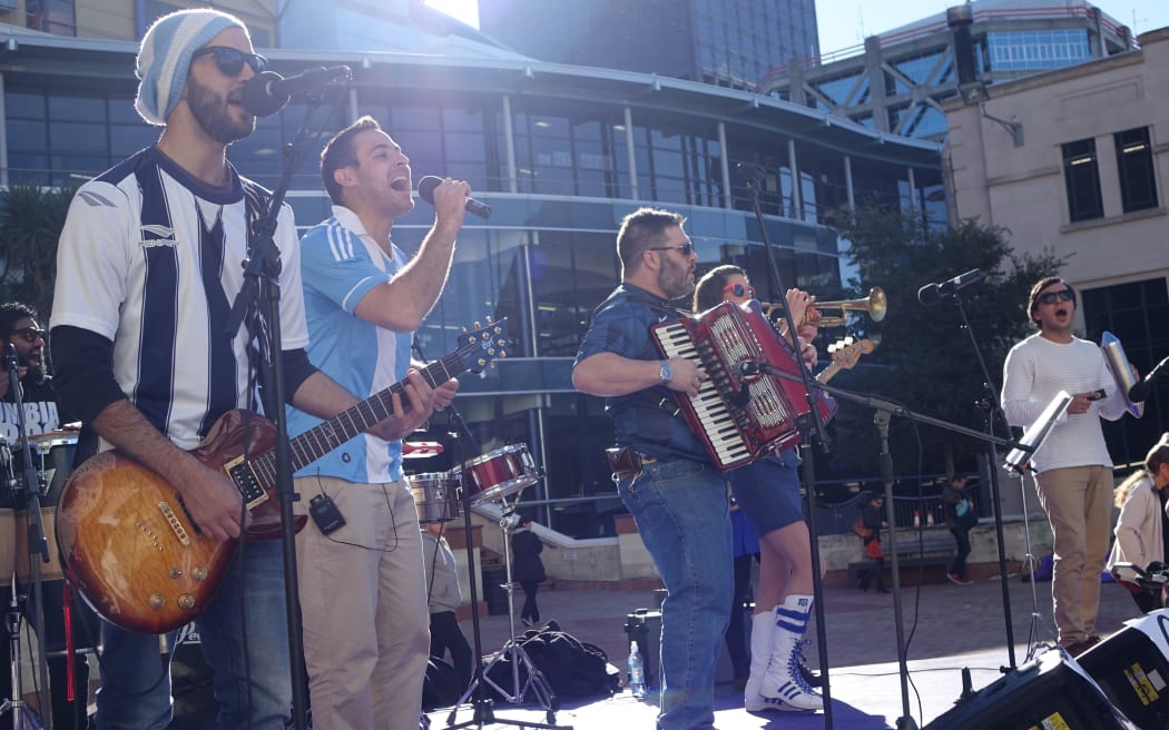 'Cumbia Bros' at the "Fever Pitch Fan Hub" in Civic Square