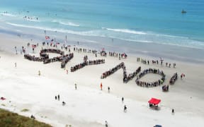 People spell out the words Say No! on Ruakaka Beach