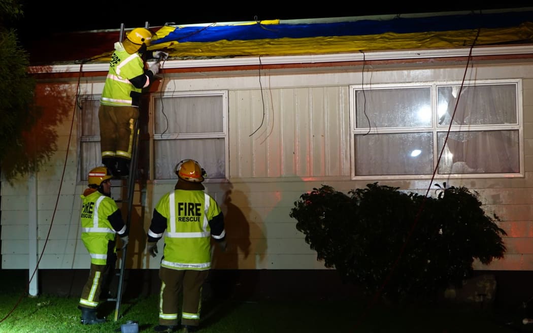 Emergency services work to secure a roof in Links Road.