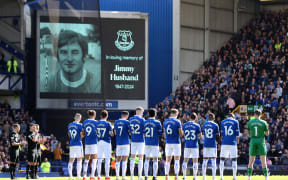 Everton players take part in a minute of applause at Goodison Park before the kick off in memory of former player Jimmy Husband.