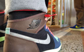 A sneakerfan wears Air Jordans as they wait in line for the latest release.