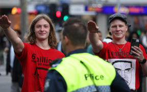 Members of the National Socialist Network perform Nazi salutes during a protest rally in Melbourne on June 4 2023. (Photo by Martin KEEP / AFP)
