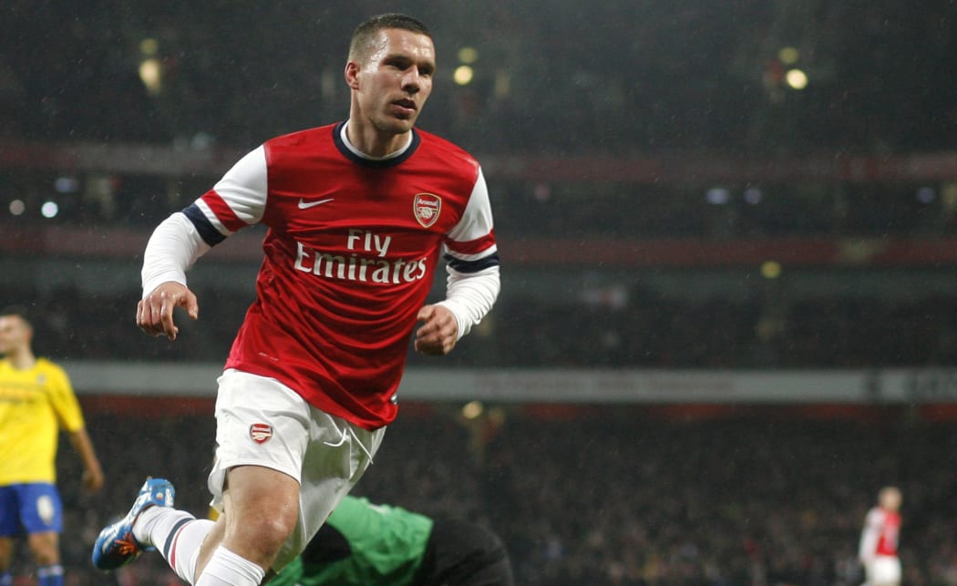 German forward Lukas Podolski scores for Arsenal.