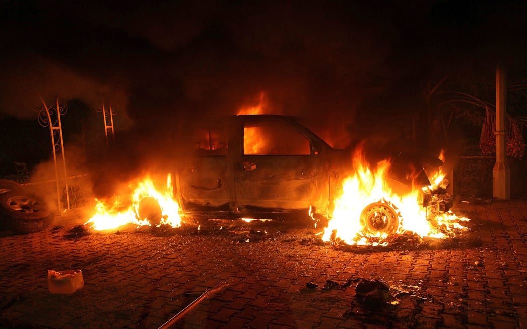 A vehicle and the surrounding area are engulfed in flames after it was set on fire inside the US consulate compound in Benghazi late on September 11, 2012.
