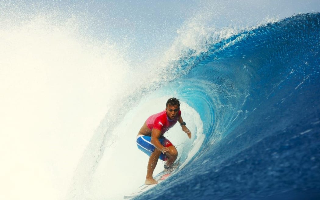 Kauli Vaast performs during a barrel surfing competition during the quarterfinals of the Olympic surfing competition in Te Ahupu, Tahiti, French Polynesia.