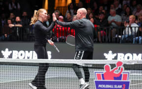 Steffi Graf (L) and Andre Agassi high-five each other as they celebrate a point during their doubles match against Eugenie Bouchard and Andy Roddick during Pickleball Slam 3 at Michelob ULTRA Arena on February 16, 2025 in Las Vegas, Nevada.