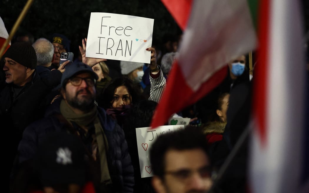 An anti-Iranian regime protester holds up a "Free Iran" placard during a gathering outside the Iranian Embassy, central London, on January 9.