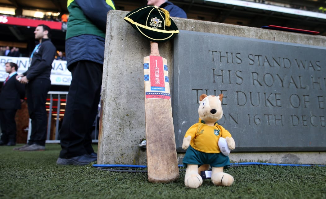 A cricket bat, a cap and a Wallaby mascot sit beside the Twickenham pitch in memory of Phil Hughes