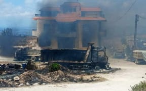 Relatives of people died when a fuel tanker exploded, set the house of owner of fuel tanker field on fire in northern Lebanon, in Akkar region on August 15, 2021. At least 28 people were killed when a fuel tanker exploded 79 others injured in the explosion.