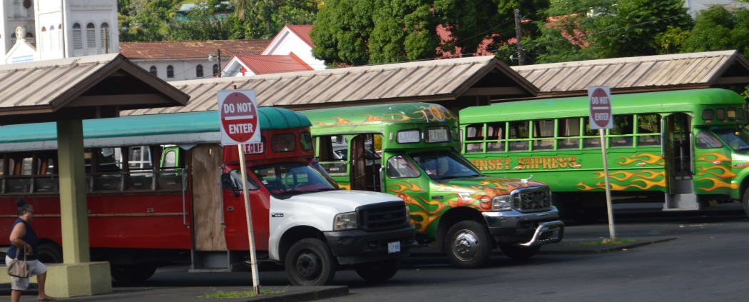 The colorful local “aiga buses” at the depot in Fagatogo