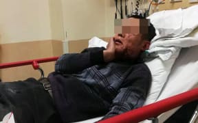 Renkun Li in hospital after he was attacked.