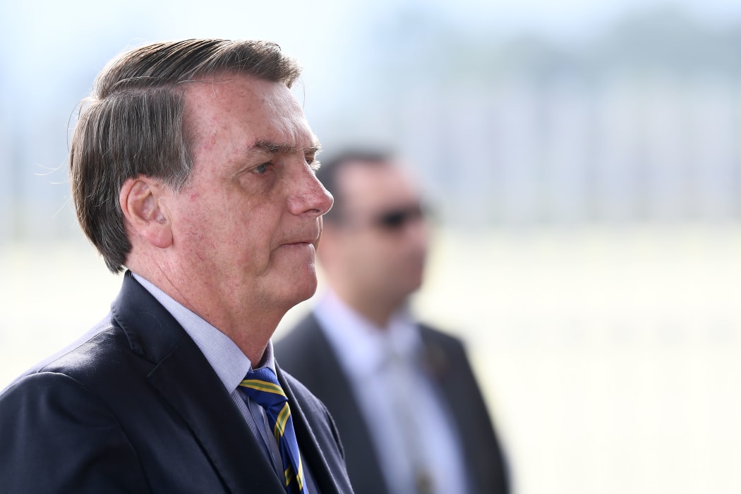 Brazilian President Jair Bolsonaro gestures as he speaks to supporters while leaving Alvorada Palace in Brasilia, on 6 May 2020.