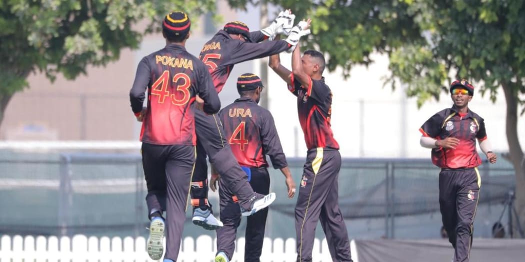 The PNG Barramundis celebrate a wicket.