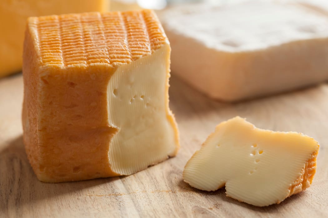 Piece of Belgian Limburger cheese on a cheese board.