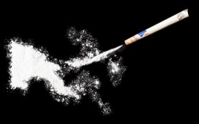 A powder drug like cocaine in the shape of Papua New Guinea with a rolled money bill.(series)