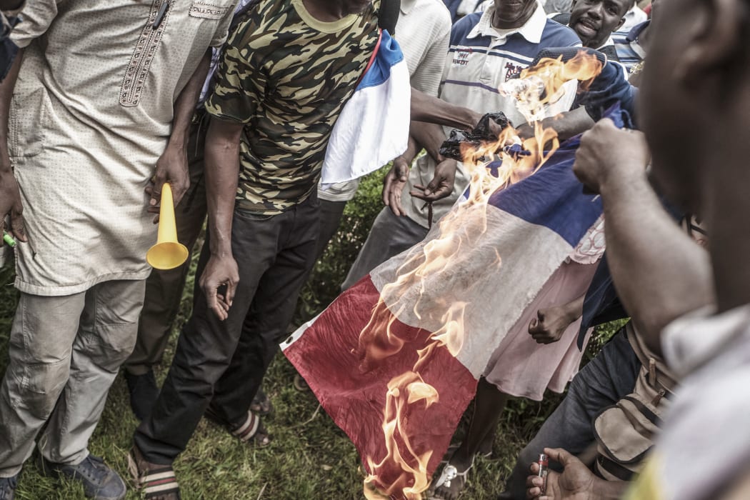 Protesters burn a French flag in Bamako during a demonstration against French influence in the country.