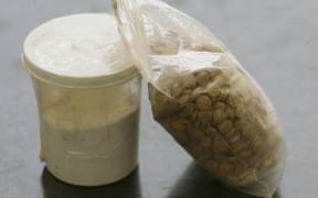 Captagon pills, along with a cup of cocaine.