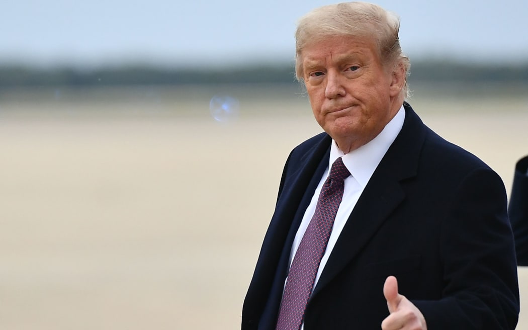 US President Donald Trump gives a thumbs up as he steps off Air Force One upon arrival at Andrews Air Force Base in Maryland on October 1, 2020. -