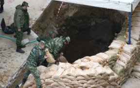 Military officers try to evacuate an unexploded World War II bomb in Thessaloniki, Greece